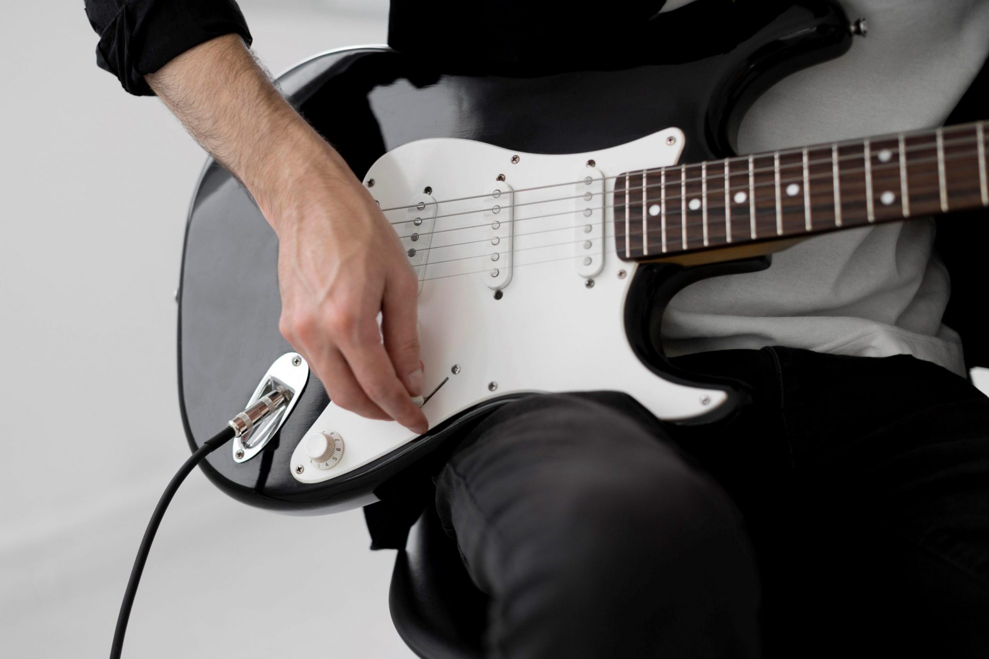 Photo of man playing electric guitar illustrates blog: "Pawning or Selling Your Guitar: a Quick Guide"