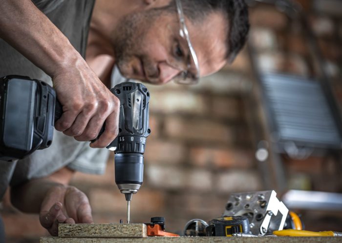 Photo of man using a drill illustrates blog: "A Guide To Pawning and Buying Tools From Your Local Pawn Shop"