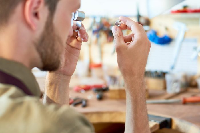 Photo of man appraising ring illustrates blogP: "What Items Will a Pawn Shop NOT Buy?"