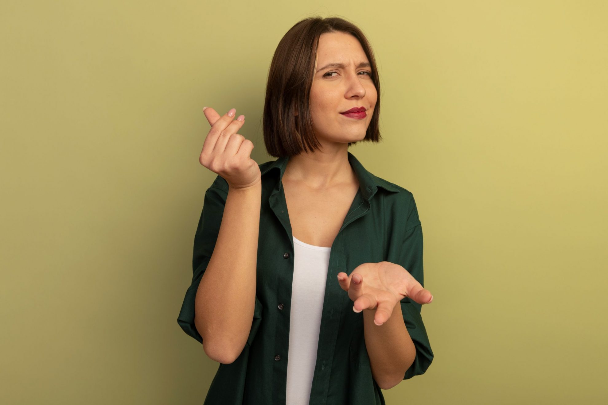 Woman making money sign with thumb and index, middle fingers illustrates blog "Pawn Shop vs Banks: When to Use Each"