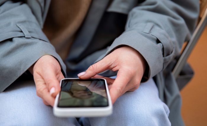 Photo of person using smartphone illustrates blog "Do Pawn Shops Have Online Inventories?"