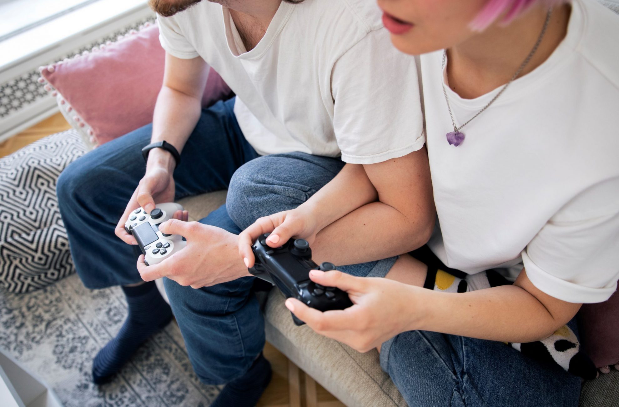 Closeup of man and woman playing video games illustrates blog "Do Pawn Shops Sell Video Games?"