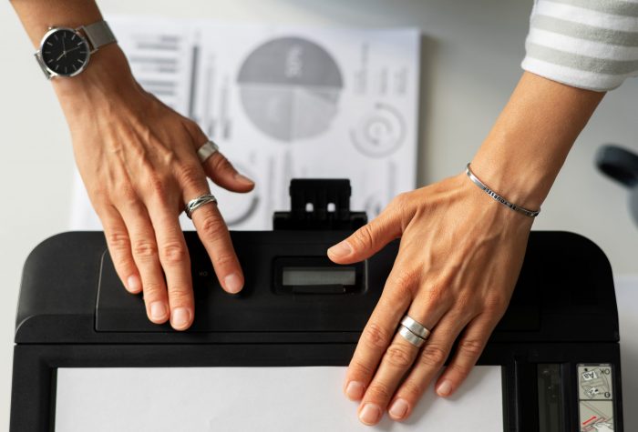 printer-FP Closeup of hands on printer illustrates blog "Do Pawn Shops Take Printers?"