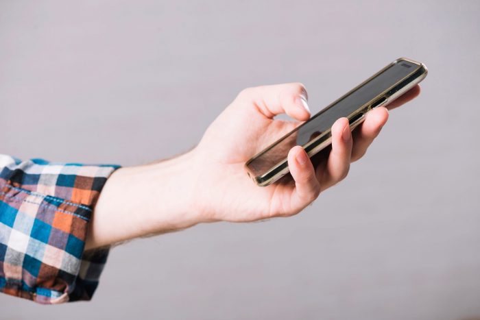 cell-phone-fp Closeup of person holding cell phone illustrates blog "Can You Pawn A Cell Phone?"