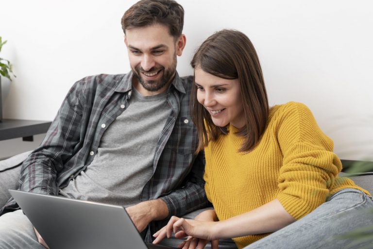Couple looking at laptop illustrates blog "Can You Shop Pawn Shops Online?"