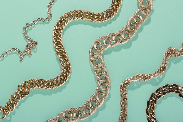Closeup of gold chains illustrates blog "To Pawn or Sell Jewelry: Which One Is Best?"