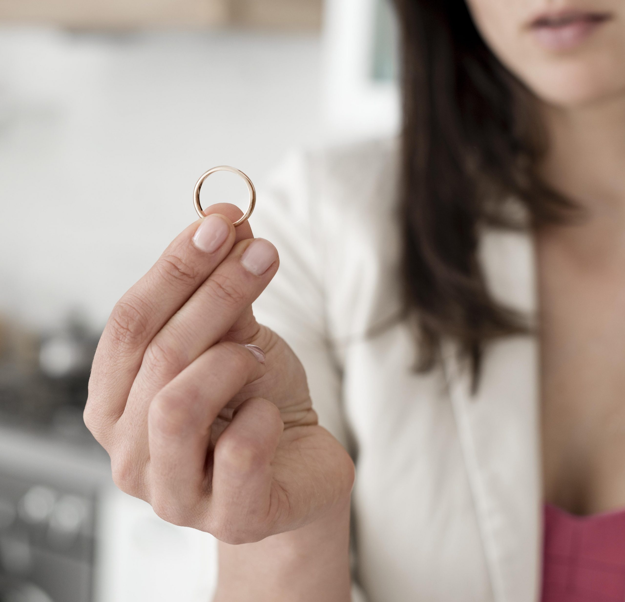 woman-holding-ring-fp Closeup of woman holding ring illustrates blog "Can You Pawn Engraved Jewelry?"