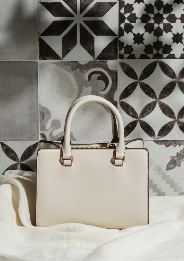 handbag-fp Luxury handbag against background of patterned tiles.