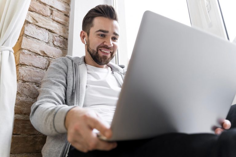 Man using laptop illustrates blog "Will a Pawn Shop Buy an HP Laptop?"