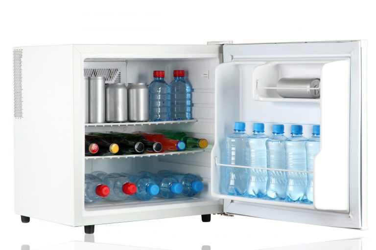 Open white frdge with beverages inside.