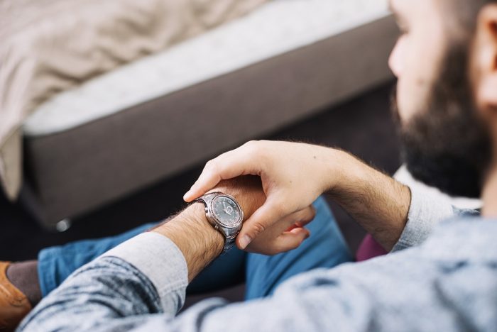 watch-man-freepik Man looking at his watch.