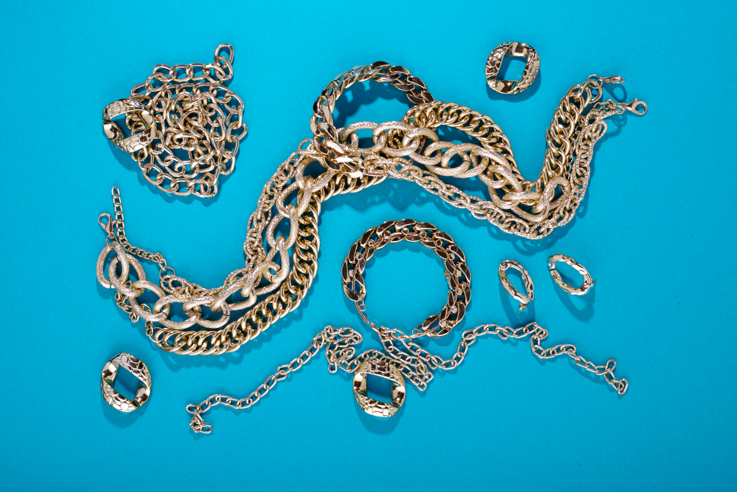 top-view-gold-chains-still-life Gold chain and loose diamond being evaluated for pawn value