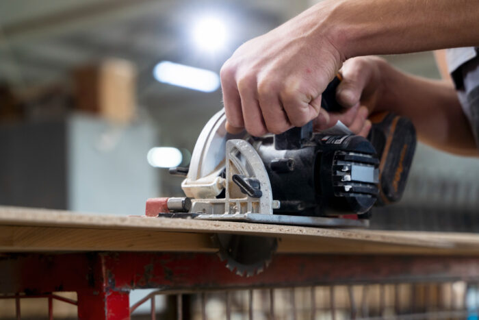 man-working-cutting-mdf-board Power tools like drills and saws ready for pawning
