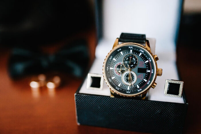 stylish-men-s-watch-cufflinks-rings-groom-bride-wedding-accessories-rustic-brown-wooden-background-idea-composition-holiday-concept Pawning designer watches for fast cash
