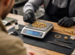 pawn shop evaluating pawn gold jewelry using scale and testing tools