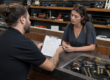 Customer reviewing pawn loan default terms at a California pawn shop