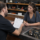 Customer reviewing pawn loan default terms at a California pawn shop