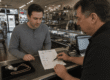 Customer learning how pawn loan interest rates work at a pawn shop